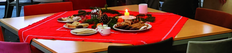 A decorated table with cookies and a lit candle
