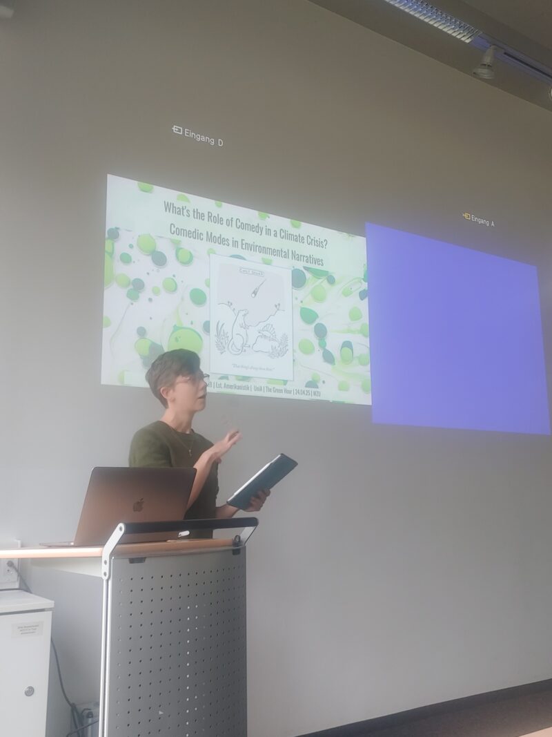 Woman presenting and standing in front of power point presentation.